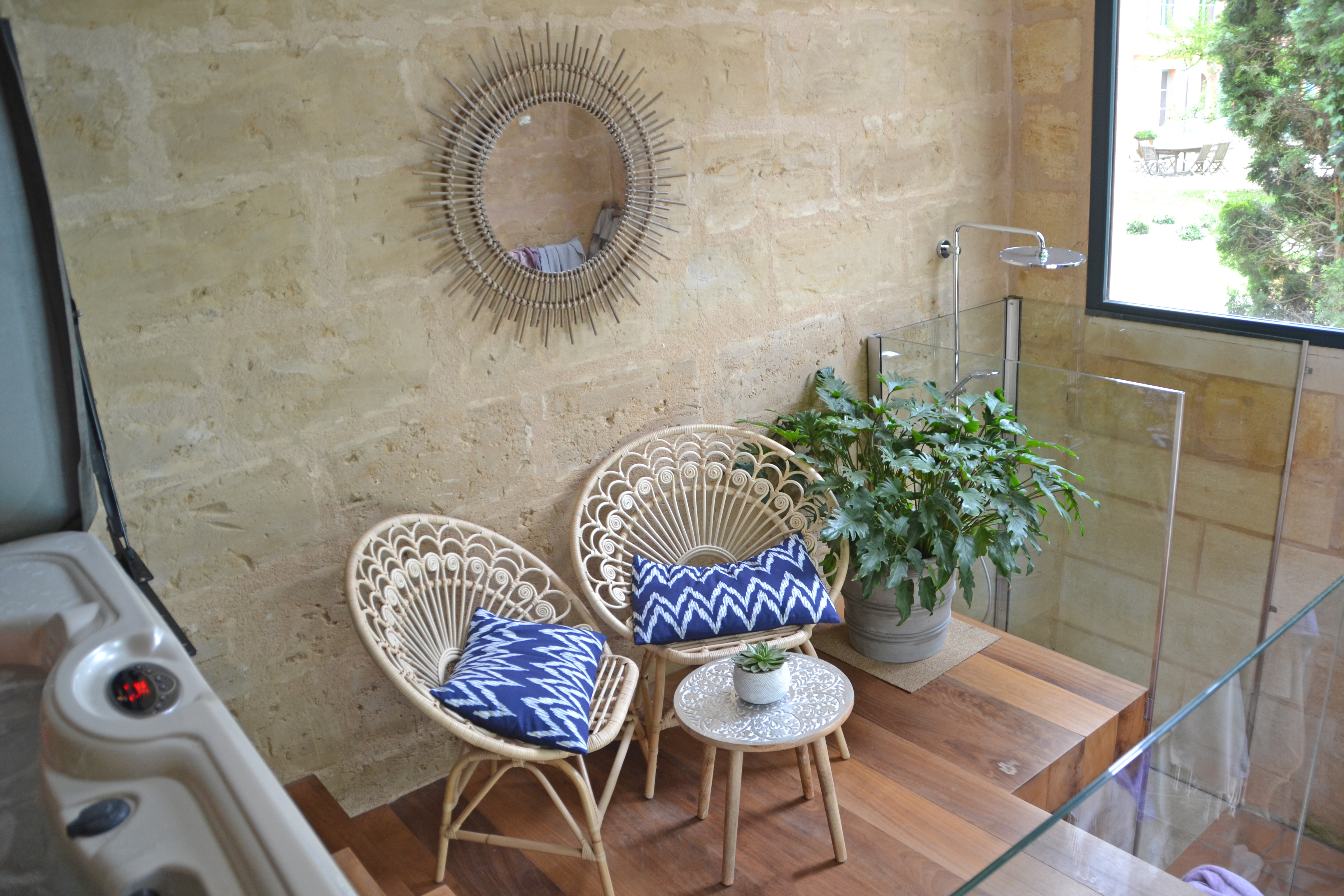 photo détail de la douche du jacuzzi, fauteuil et miroir en osier avec coussins bleus et blancs, chambres d'hôtes château Pont Saint-Martin, Pessac Léognan, Bordeaux